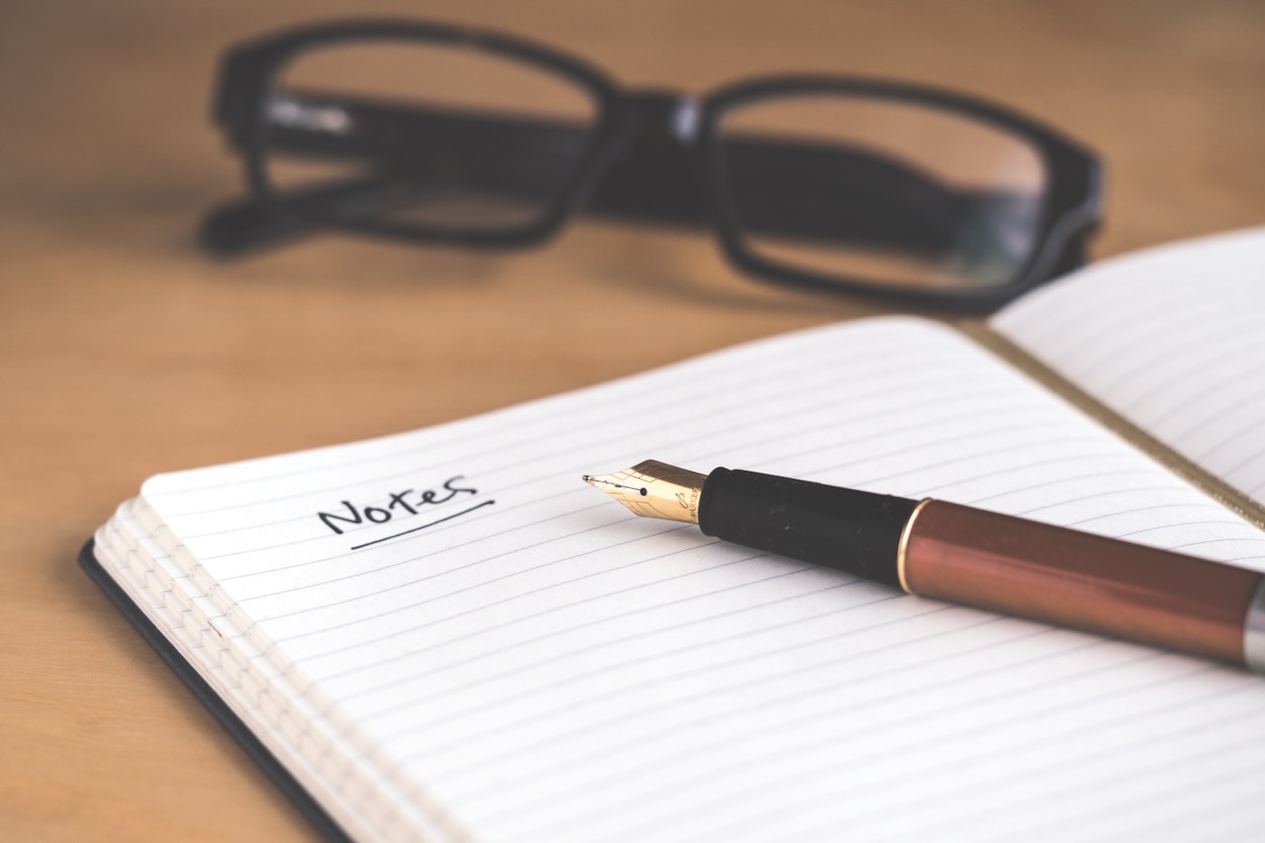 An open journal with a pen